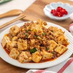 Mapo tofu. Stir-fried tofu with hot spicy sauce in white plate.