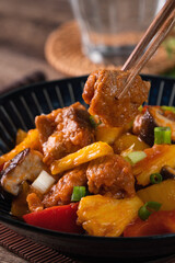 Sweet and sour sauced deep fried pork with chopped pepper and pineapple.