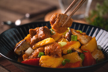 Sweet and sour sauced deep fried pork with chopped pepper and pineapple.