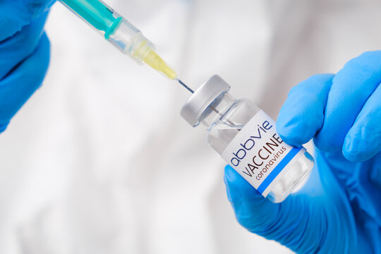 Abbvie vaccine against coronavirus collected into the syringe by health worker or doctor in protective gloves and PPE suit, April 2021, San Francisco, USA