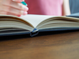 Women who are taking notes to work, focus on books