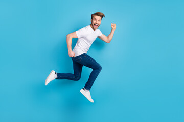 Fototapeta na wymiar Full size profile portrait of excited cheerful guy open mouth look camera isolated on blue color background
