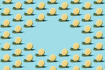 Creative pattern made with fresh lemons on cyan background. Minimal summer fruit layout.