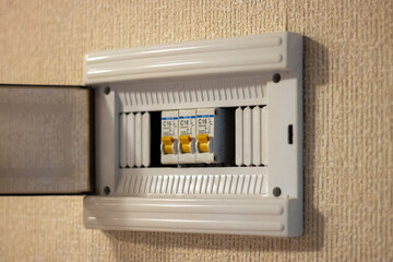 Close-up of an electrical panel with circuit breakers in the apartment. Voltage distributor with...