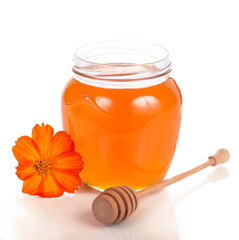 glass pot with floral honey isolated on white background.