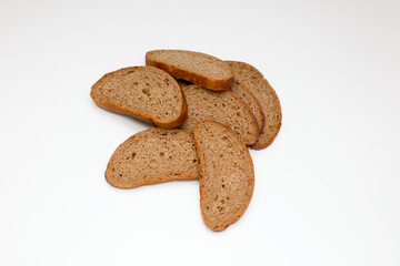 pieces of gray rye unleavened healthy bread on a white background