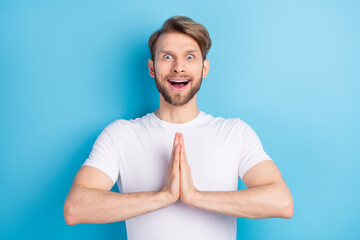 Portrait of impressed cheerful person open mouth hands palms pleading isolated on blue color...