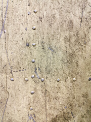 texture of a very old metal garage wall with rivets and scratches