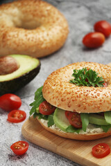 Sesame bagels with tomatoes and avocado
