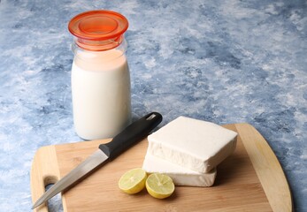 paneer making recipe ingredients, milk and lemon with fresh cottage cheese.