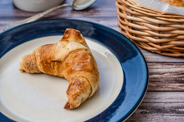 Croissant or medialuna on a small plate.