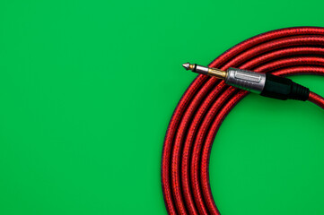 Guitar cable on a green background