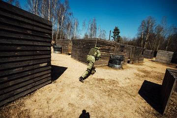 a laser tag game on the training ground. military tactical training with laser weapons. players in military uniforms run around the training ground playing war