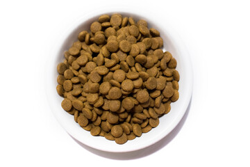 Dry food for cats and dogs in a white bowl. Studio white background.