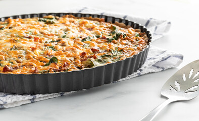 Close up of a freshly baked quiche ready for serving.