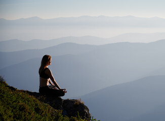 Side view of young woman enjoying nature and beautiful landscape. Concept of meditation.