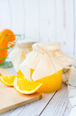 Orange jam is packed in beautiful jars.
