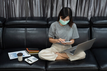 Woman in quarantine for Coronavirus (COVID-19) pandemic wearing protective mask and take care of their health online training education and freelance work, working from home, stay at home concept.