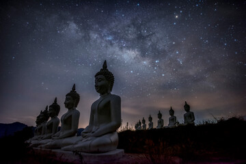 Milky way galaxy over many of buddha statues at Phu Phra Ban Mak Khaeng, Dan Sai, Loei, Thailand.