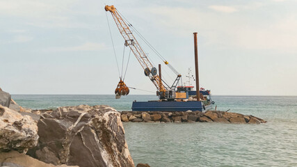 naval crane rebuilds a cliff