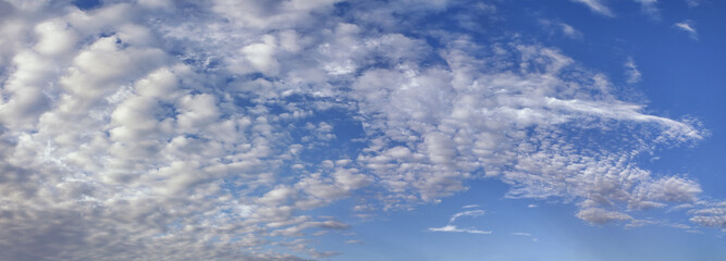 Gorgeous blue sky littered with fluffy white clouds in a circular pattern