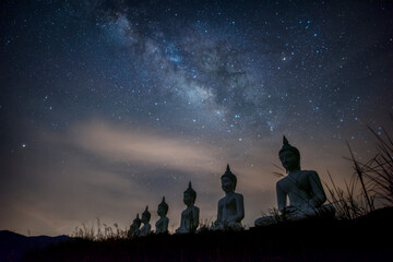 Milky way galaxy over many of buddha statues at Phu Phra Ban Mak Khaeng, Dan Sai, Loei, Thailand.