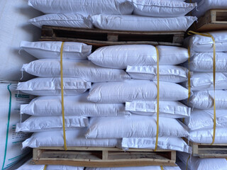 Fototapeta na wymiar Chemical fertilizer The product stock is packed in sacks, stacked in the warehouse, waiting for delivery. 