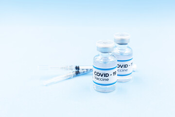Vaccine and syringe injection, treatment to cure Covid 19 Coronavirus. , Its uses for prevention, immunization, and treatment, Medical concept, isolated on blue background