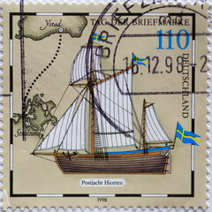 GERMANY - CIRCA 1998  : a postage stamp from Germany, showing a historic sailing ship the post yacht Hiorten. on the day of the postal stamp