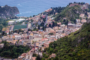 Fototapeta na wymiar Taormina city seen from Castelmola town in the Province of Messina in the Italian region Sicily, Italy
