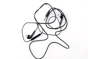 black wired headphones on a white background. vacuum headphones