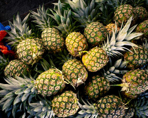 large batch of sweet and ripe pineapples for sale in public market