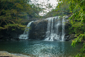 Obraz na płótnie Canvas A beautiful waterfall in the middle of the forest located in Srilanka