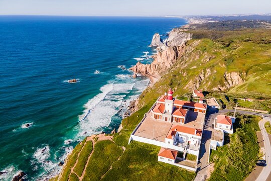 Aerial view of Cabo da Roca lighthouse, a natural coastline with a viewpoint over the cliffs facing the Atlantic Ocean, Colares, Lisbon, Portugal.