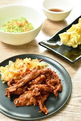 grilled slice pork dressing Sichuan pepper sauce and Chinese jade noodles dressing crispy fried chop garlic with steamed Chinese dumpling stuffed mashed pork on table