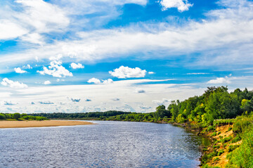 summer landscape with river and blue sky with clouds