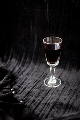 glass of red wine on a black velvet background, close-up