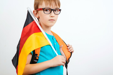 Cute student holding german flag. Kid kearning German. Lessons and learning of foreign languages....
