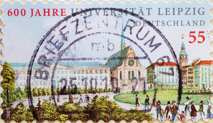 GERMANY - CIRCA 2009 : a postage stamp from Germany, showing some historical buildings with people in front of Leipzig University. 600 years