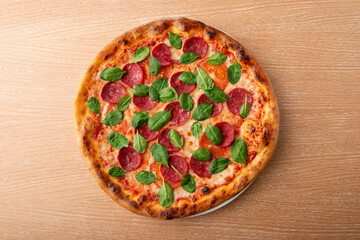 Pepperoni pizza with fresh basil leaf