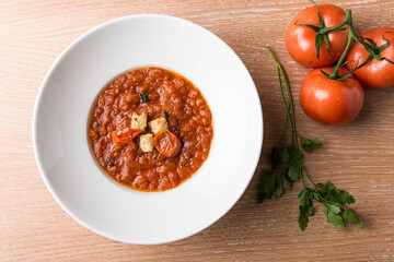 Italian Baked tomato gravy with toasted bread with beef tomato and salad