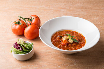 Italian Baked tomato gravy with toasted bread with beef tomato and salad