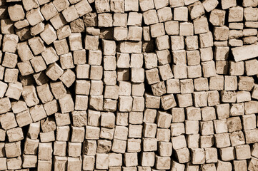 cobblestone piled in a heap. brick gray wall. dark unusual texture. geometric background