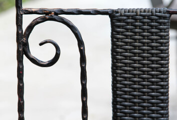 Backrest of modern black steel outdoor chair.