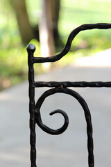 Backrest of modern black steel outdoor chair.