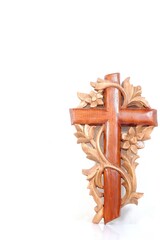 A beautiful handmade wooden cross on a white background 