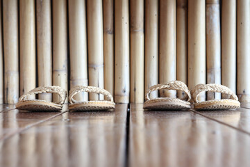 On the wooden floor, the shoe weave hotel and bamboo wall background.