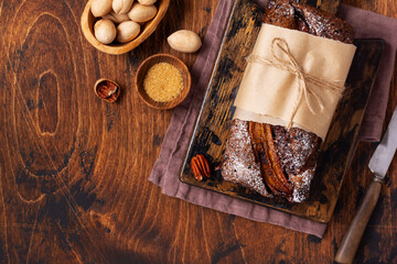 Banana bread with cinnamon crunch and sprinkled with icing sugar on light concrete background. Selective focus, space for text