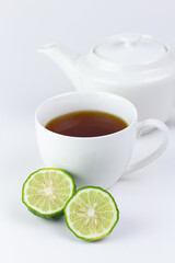 Bergamot tea or Earl Grey tea in white cup and fresh bergamot fruit with sliced isolated on white background.