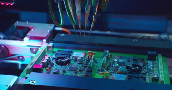 modern industrial equipment.industrial robot assembles an electronic board.technological process of assembling a complex technical product .close-up